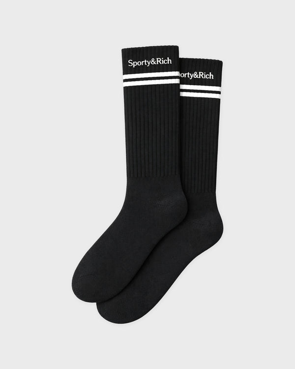 Black socks with white stripes and 'Sporty&Rich' branding on a light gray background