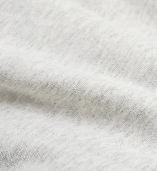 Close-up of a soft Heather Gray/Navy fabric woven into a textured, elegantly crafted USA crewneck with gentle folds.