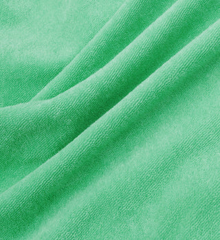 Close-up of the Prince Sporty Terry Polo in Clean Mint/White, showcasing soft 100% cotton fabric with visible texture and gentle folds. Made in Portugal.