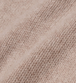 Close-up of the Vendome Cashmere Short in Oatmeal/White, showcasing beige knit fabric with textured stitches, diagonal lines, soft cashmere detail, and a subtle embroidered logo.