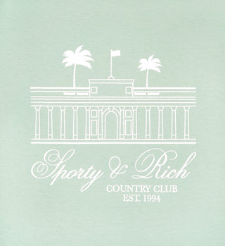 The Villa T-Shirt - Jade/White features a white line country club and palm trees graphic with Sporty & Rich Country Club Est. 1994 text. Made in Los Angeles from USA-grown cotton for lasting comfort and quality.