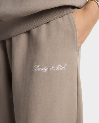 Brown pants with 'Spacy & Rich' embroidery on a white background