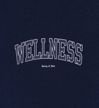 The Wellness Ivy Biker Short - Navy/White features high-waisted navy cotton spandex, WELLNESS in bold white letters, and Sporty & Rich in smaller text underneath for a stylish, comfortable look.