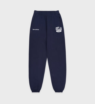 Navy sweatpants with 'UCLA' and 'Sperry & Rich' logos on a light gray background