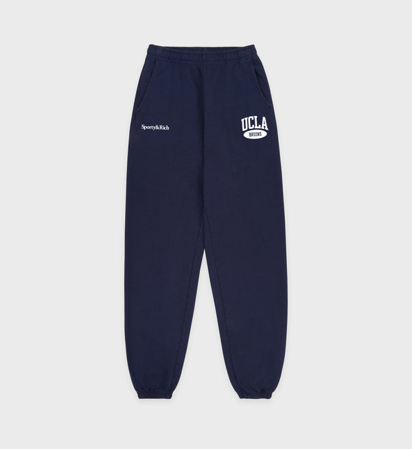 Navy sweatpants with 'UCLA' and 'Sperry & Rich' logos on a light gray background