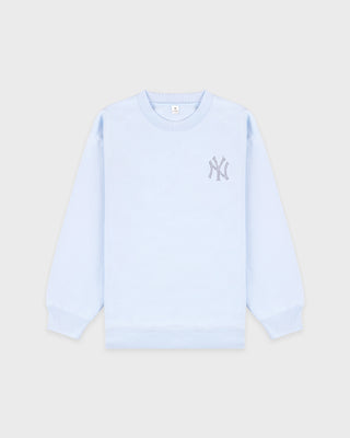 Light blue sweatshirt with a logo on a beige background