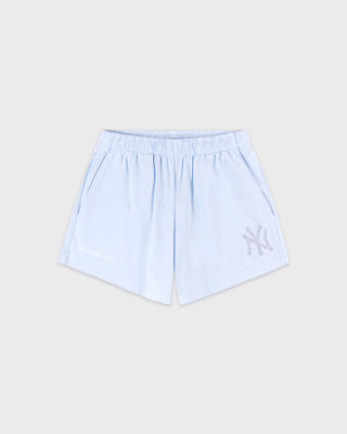 Light blue shorts with a logo on a beige background