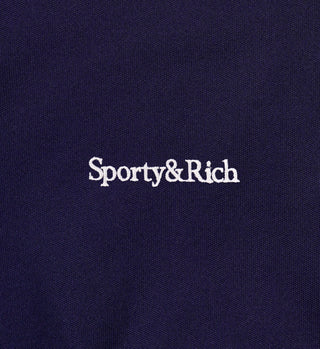Navy blue fabric with 'Sporty & Rich' logo embroidered in white.
