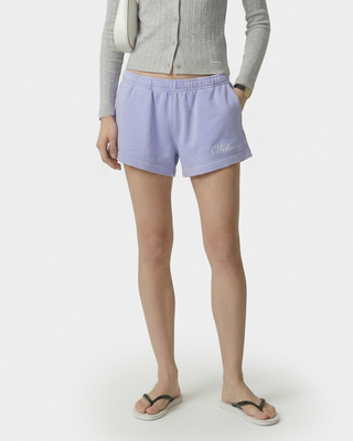 Person wearing lavender shorts with a brand logo on a white background