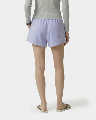 Person wearing light purple shorts on a white background