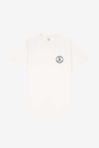 Ecru Cadillac x Sporty & Rich Atlas Tee with a small circular blue and black logo on the left chest, laid flat on a white background. Made from premium USA grown cotton, this tee offers timeless style and exceptional comfort.