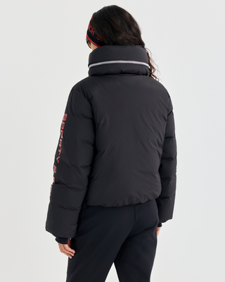 Drea Bold Logo Ski Jacket in black with an oversized fit, red interior collar, and red sleeve text.