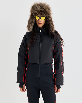 Dulce Bold Logo Hooded Ski Suit in black with a front zipper and red piping accents.