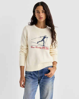 Ivylee Cross Country Knitted Sweater - Ecru: a cream, breathable knit with a skier graphic and red club text.