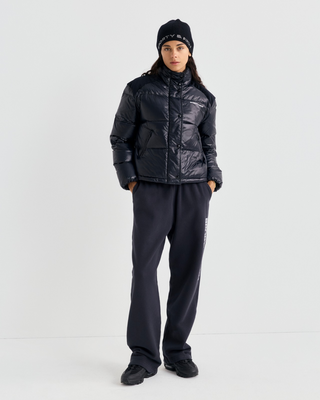 Black Devan Bold Logo Mountain Puffer with a boxy fit, mock neck, front zip, and white chest logo.