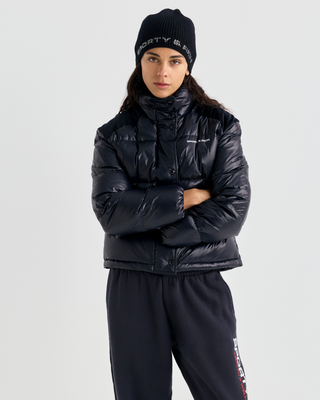 Black Devan Bold Logo Mountain Puffer with a boxy fit, mock neck, front zip, and white chest logo.