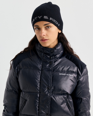 Black Devan Bold Logo Mountain Puffer with a boxy fit, mock neck, front zip, and white chest logo.
