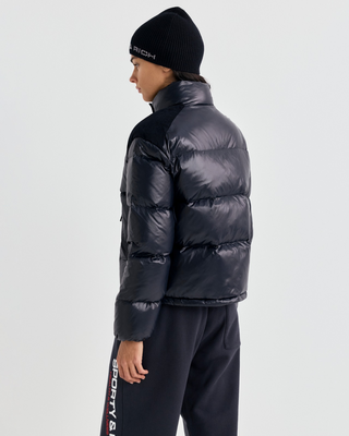 Black Devan Bold Logo Mountain Puffer with a boxy fit, mock neck, front zip, and white chest logo.