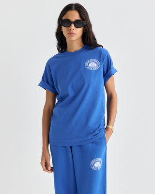 Vibrant blue Cameron Chateau Tshirt featuring a white circular logo on the chest.
