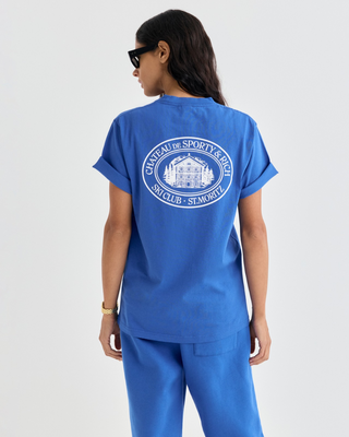 Vibrant blue Cameron Chateau Tshirt featuring a white circular logo on the chest.