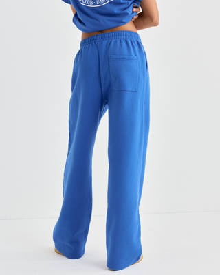 Blakely Chateau Wide Sweatpant in vibrant blue with a wide-leg fit and a circular white graphic on the hip.