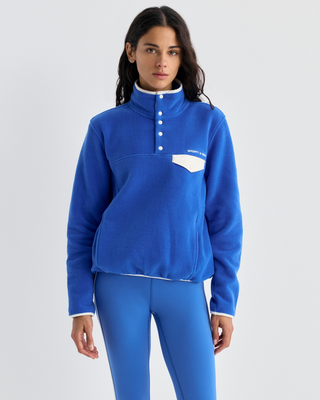 Emma Bold Logo Polar Sweatshirt in vibrant blue with a snap-button mock neck and a cream chest pocket.