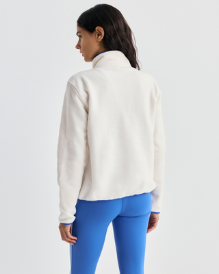 Emma Bold Logo Polar Sweatshirt in cream-colored polyester fleece with a snap-button placket and blue trim.