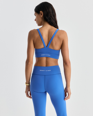 Flor Bold Logo Active Bra in vibrant blue performance fabric with white side stripe detailing.