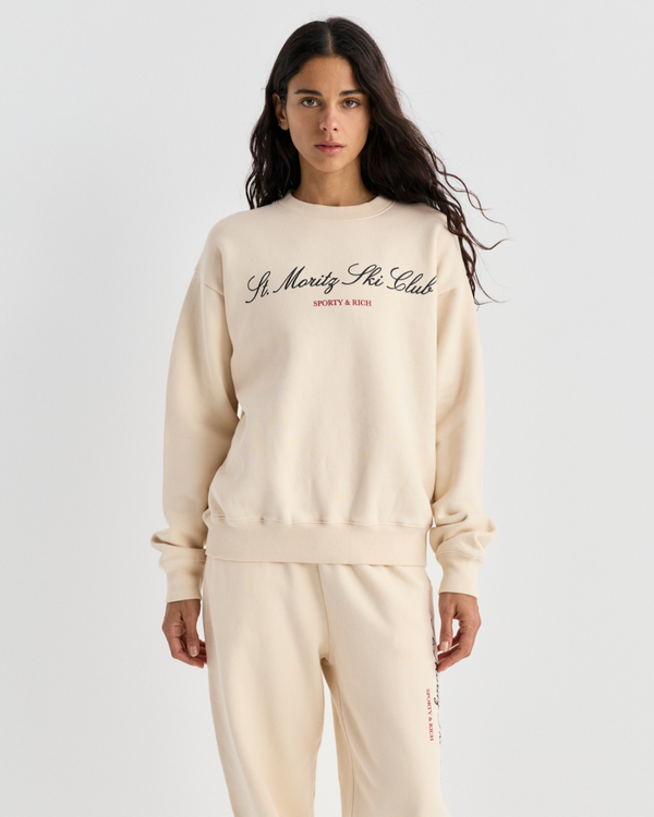 Cream Emmett Ski Club Crewneck sweatshirt with St Moritz Ski Club printed on the chest.