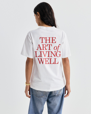 White Cameron Art Tshirt with a small red logo on the chest.