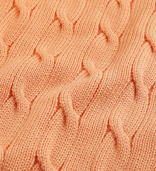 Close-up of the SRC Cotton Cableknit Sweater in Grapefruit, featuring a wavy textured pattern and expertly crafted from cotton in Portugal.