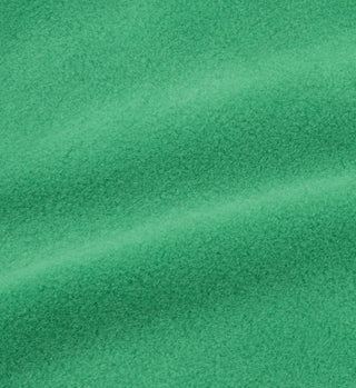 Close-up of the Kelly/Cream Buttoned Polar Sweatshirt shows its bright green textured fabric with a soft, fuzzy surface and gentle folds—ideal for cozy winter wear.