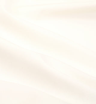 The Carla One Piece - Cream features soft white fabric with gentle folds, crafted from ECONYL® regenerated Nylon for a smooth and serene texture.