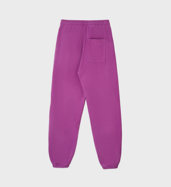 The Classic Logo Sweatpant - Magenta features an elastic waistband, elastic cuffs, a single back pocket, and is crafted from 100% cotton.