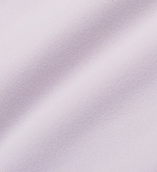 The Club Logo Legging - Faded Lilac features smooth, soft light lavender fabric with gentle diagonal folds, making it perfect for stylish high-waisted leggings.