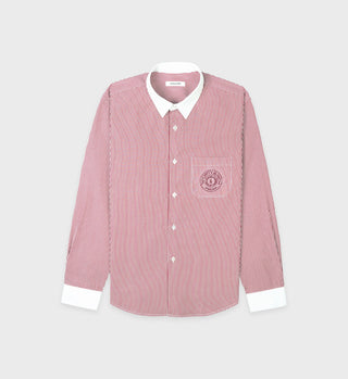 The Connecticut Crest Striped Shirt - Merlot features red and white cotton poplin stripes, a white collar and cuffs, and a Connecticut Crest embroidered on the chest. Made in Portugal.