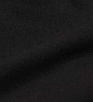 Close-up of smooth black fabric with subtle folds and a soft texture, ideal for the Cropped Tank N.03 - Black, featuring a built-in shelf bra for support.