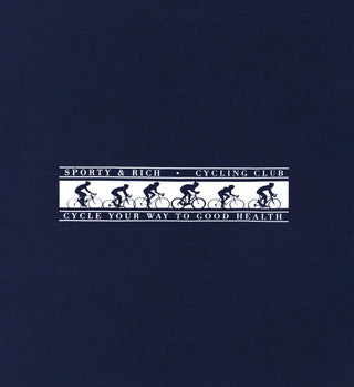 The Cycling Club T-Shirt - Navy features white cyclist silhouettes and Sporty & Rich Cycling Club text on a navy background. Made in the USA, it’s perfect for cycling in style while promoting good health.