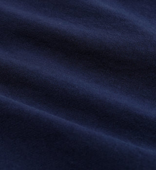 Close-up of navy 100% cotton fabric with visible texture and gentle folds, featured in the Cycling Club T-Shirt - Navy.