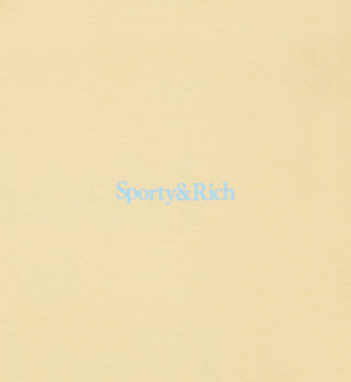 The Health Is Wealth T-Shirt - Almond/H2O is a light yellow unisex tee featuring Sporty&Rich in light blue at the center, crafted from USA-grown cotton.