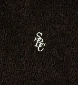 White embroidered SRC monogram on a dark brown, textured 100% cotton terry fabric, featured on the SRC Longsleeve Terry Polo - Chocolate.