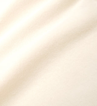 The NY Racquet Club T-Shirt - Cream/Verde features soft, cream-colored 100% USA-grown cotton with gentle folds and a smooth, lightly textured surface—proudly made in the USA.