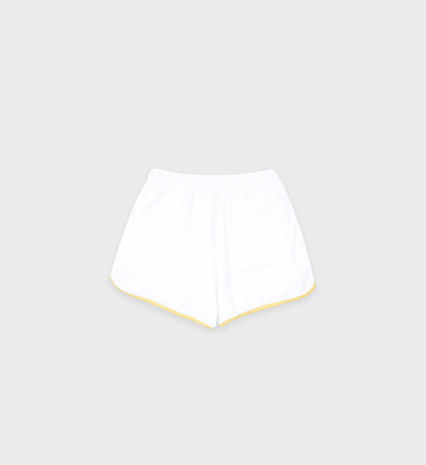 The Prince Sporty Terry Short in White/Yellow, made from soft cotton, is shown flat on a light gray background with its back pocket visible.