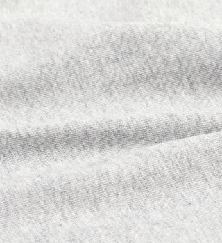 Close-up of the Heather Gray/White Serif Logo Muscle Tee fabric, showing its soft, slightly textured surface and subtle creases—highlighting quality details in this unisex tee made in the USA.