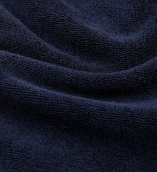 Close-up of SRC Terry Short - Navy, crafted in Portugal from 100% cotton terry cloth. The dark navy fabric shows soft texture and gentle folds—ideal for comfortable, stylish shorts.