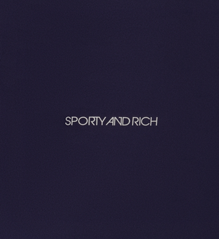 White text SPORTY AND RICH is centered on the navy Sports Bra N.03, emphasizing both comfort and support.