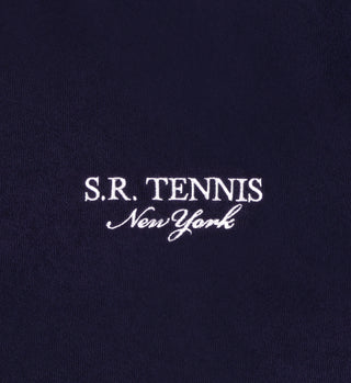 The SR Tennis Terry Polo - Navy/White features white embroidered S.R. TENNIS New York text on dark blue 100% cotton fabric, combining comfort and style.
