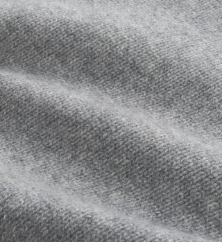 Close-up of the SRC Cashmere Hoodie - Gray, featuring soft light gray knitted fabric with a textured surface and gentle folds for a cozy, luxurious feel.