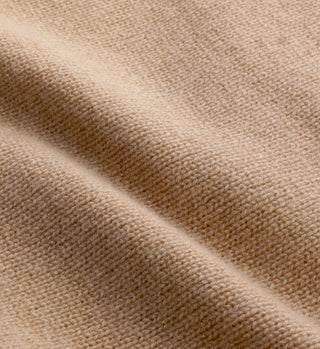 Close-up of the SRC Cashmere Sweatpant in Camel, showcasing its beige wool fabric with a textured, woven surface and gentle folds for a luxurious feel.