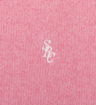 The SRC Cashmere Sweatpant - Pink features soft pink knitted fabric with a white embroidered SPC logo at the center, perfect for cozy comfort.